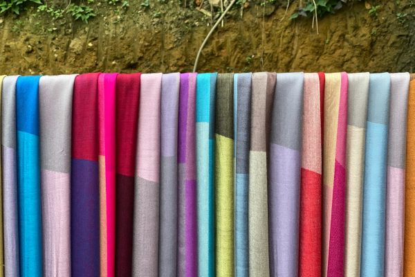 a row of colorful towels hanging on a clothes line